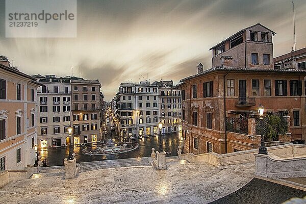 View over a beautiful historic Roman city. At one of the sights  with old buildings and urban flair. Morning sunrise at the Spanish Steps Scalinata di Trinità dei Monti  Rome  Italy  Europe