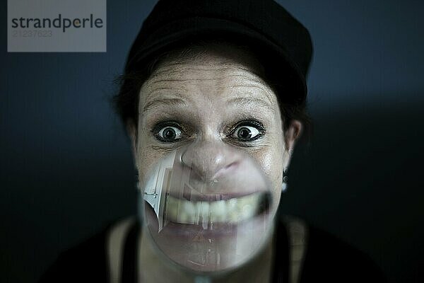 Woman with magnifying glass  grimace