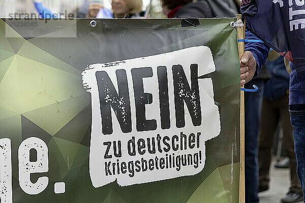 Poster in the layout of the German Armed Forces with the inscription No to German involvement in war at the Die Waffen nieder demonstration on Breitscheidplatz in Berlin. The event is directed against all wars and calls for an immediate stop to all arms deliveries. Berlin  03.10.2024