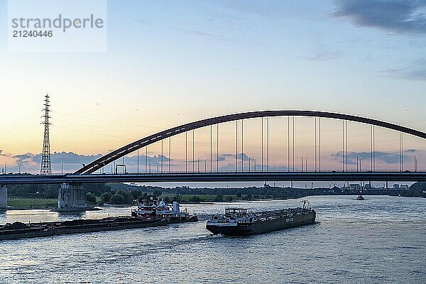 The Bridge of Solidarity  the longest tied-arch bridge in Germany  over the Rhine from Duisburg-Hochfeld to DU-Rheinhausen  the road bridge is dilapidated and has to be rebuilt  many thousands of lorries from the Logport port and cars use the bridge every day  new construction by 2040  cargo ships  Duisburg  North Rhine-Westphalia  Germany  Europe