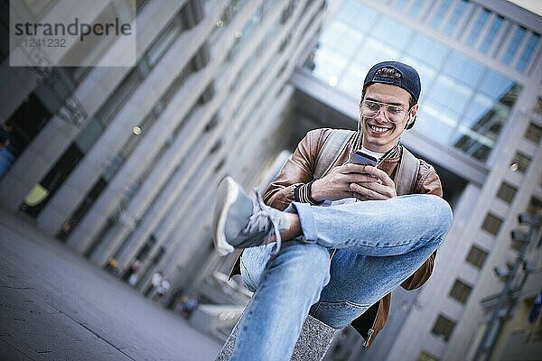 Man Sitting Listening Music Earphones Concept. Cheerful young guy listening the music