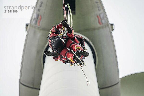 Height rescuers from the Gelsenkirchen fire brigade practise abseiling from a wind turbine from a height of 110 metres after rescuing an accident victim from the nacelle  Gladbeck  North Rhine-Westphalia  Germany  Europe