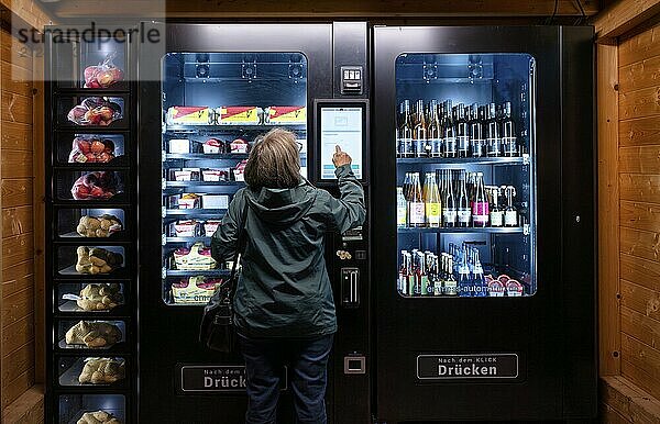 Elderly woman buying groceries at vending machine  display  food vending machine  farm shop  Stuttgart  Baden-Württemberg  Germany  Europe