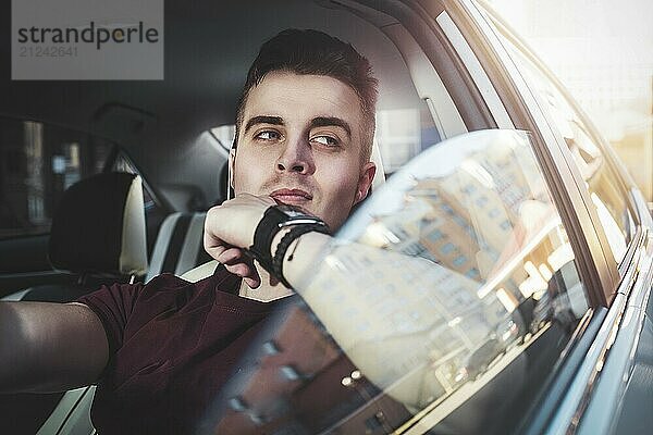 Enjoy the drive. Image of young handsome guy sitting in car