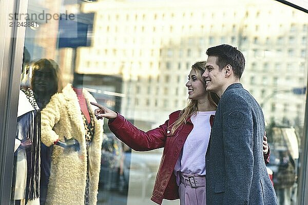 Beautiful young couple enjoying in shopping  having fun together. Consumerism  love  dating  lifestyle concept