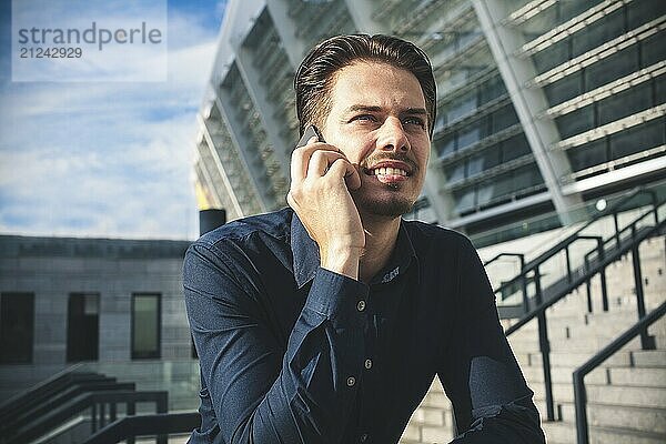 Happy businessman stand on stairs and dreaming about something