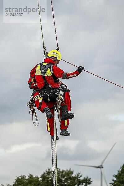 Height rescuers from the Gelsenkirchen fire brigade practise abseiling from a wind turbine from a height of 110 metres after rescuing an accident victim from the nacelle  Gladbeck  North Rhine-Westphalia  Germany  Europe