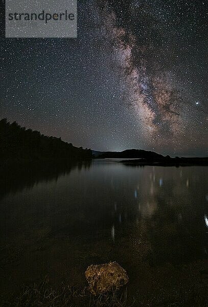 Milchstraße und rosa Licht in den Bergen. Nacht bunte Landschaft. Sternenhimmel mit Hügeln im Sommer. Schönes Universum. Space Hintergrund mit Galaxie. Reisen Hintergrund