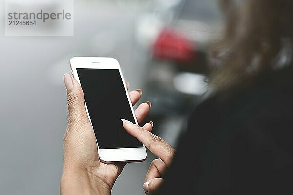 Cropped image of woman's hands holding smart phone with blank copy space screen for your text message or promotional content  female chatting in network on cell telephone