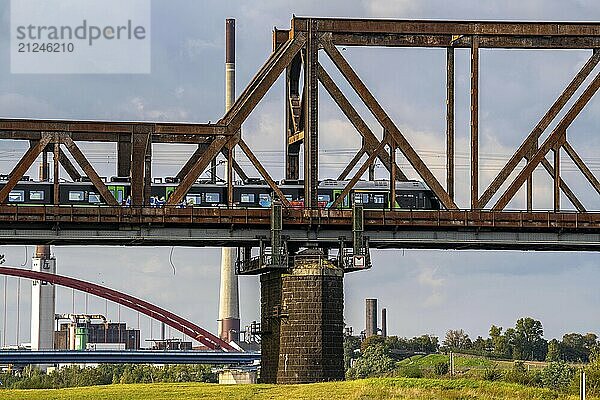 The railway bridge Duisburg-Hochfeld-Rheinhausen  over the Rhine  regional trains and many goods trains cross the Rhine here  from 1950  steel truss bridge  in the background the Bridge of Solidarity in DU-Rheinhausen  road bridge  Duisburg  North Rhine-Westphalia  Germany  Europe