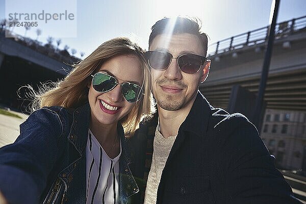 Happy young couple in love takes a selfie portrait