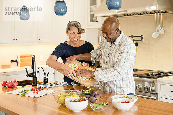 Couple working together in the kitchen to make a healthy meal