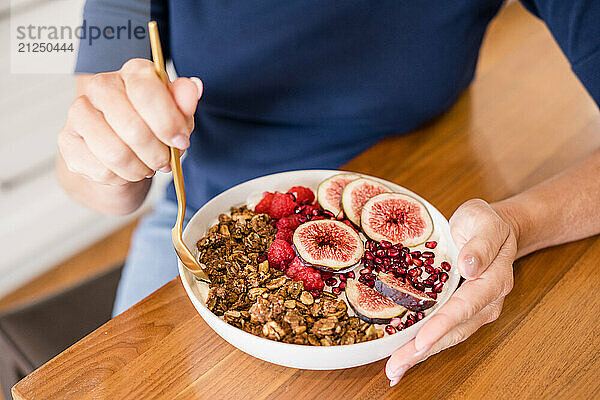 Woman holding a bowl of yogurt