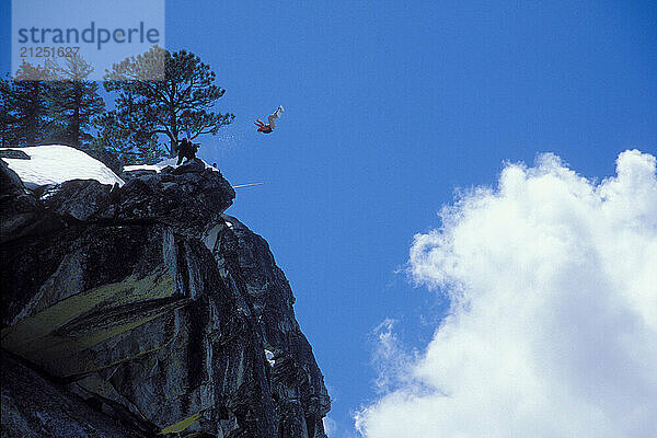 Mark Ridley pulling a back flip while Snowboard-BASE jumping at Lover's Leap  near Lake Tahoe. Board-BASEing is a hybrid of extreme snowboarding and BASE jumping in which one rides off a steep cliff with a parachute.