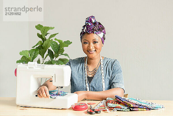 Beautiful Nigerian woman smiling while sowing