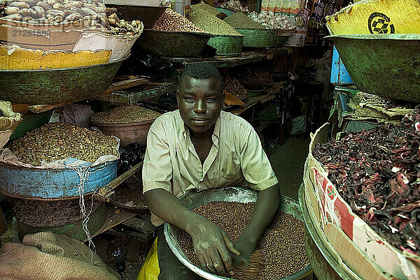 Boy clearing away a kind of lentils on Hai el-Arab Souq in Omdurman  Sudan.