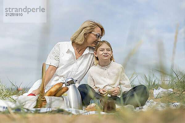 Mother and daughter enjoying picnic leisure together