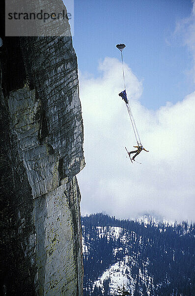 Max Kuszej ski-BASE jumping at Lover's Leap  near Lake Tahoe. Ski-BASEing is a hybrid of extreme skiing and BASE jumping in which one skis of a steep cliff with a parachute. There is little room for error.