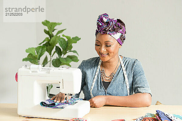 African american woman using a sowing machine