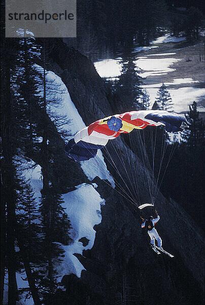 Jesse Hall ski-BASE jumping at Lover's Leap  near Lake Tahoe. Ski-BASEing is a hybrid of extreme skiing and BASE jumping in which one skis off a steep cliff with a parachute.