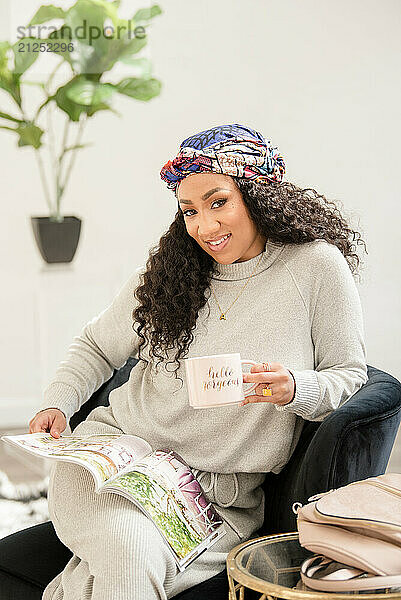 Lifestyle type photo with woman sitting down holding a cup of coffee