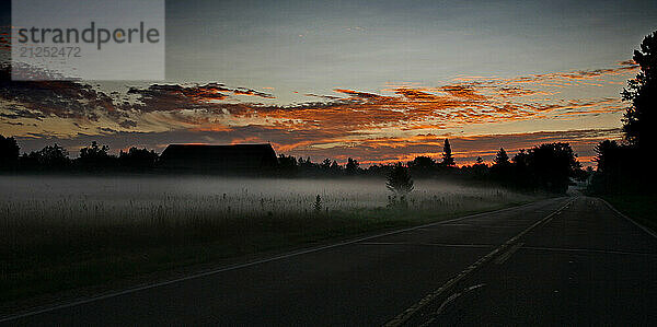 Ground fog hovers as sunrise begins along a county road in the Town of Saukville  Wi.