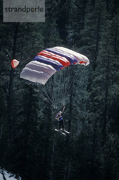 Miles Daisher ski-BASE jumping at Lover's Leap  near Lake Tahoe. Ski-BASEing is a hybrid of extreme skiing and BASE jumping in which one skis of a steep cliff with a parachute.