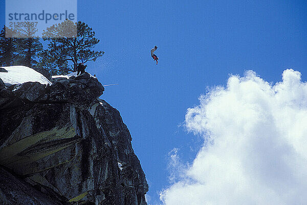 Mark Ridley pulling a back flip while Snowboard-BASE jumping at Lover's Leap  near Lake Tahoe. Board-BASEing is a hybrid of extreme snowboarding and BASE jumping in which one rides off a steep cliff with a parachute.