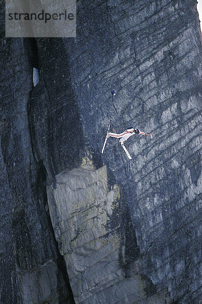 Jesse Hall doing a front flip while ski-BASE jumping at Lover's Leap  near Lake Tahoe. Ski-BASEing is a hybrid of extreme skiing and BASE jumping in which one skis off a steep cliff with a parachute.