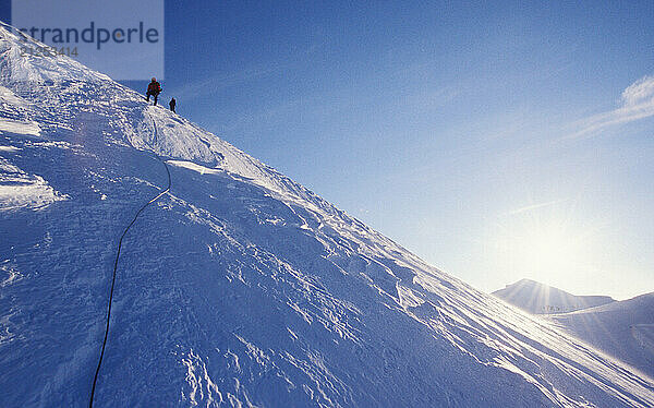 Climbers descending from a climb of Liberty Ridge on the North side of Washingon's Mt. Rainier. Mount Rainier National Park is in the Cascades Mounain Range near Seattle  and is very popular for skiing and mountaineering.