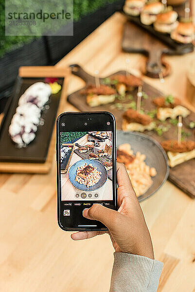 Woman taking a photo of a display of foods