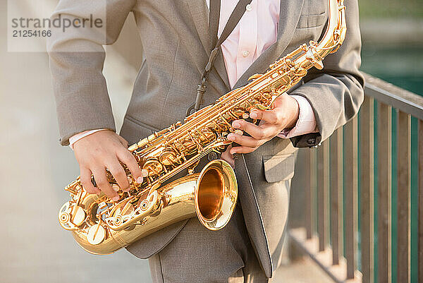 Close up of a young boy playing the saxophone