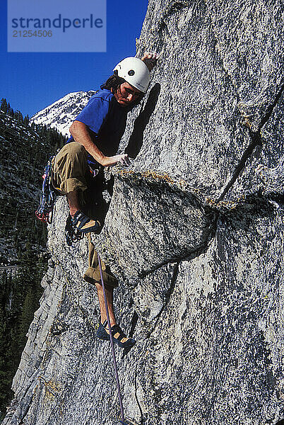 Kevin Jorgeson climbing Fantasia at Lover's Leap  a popular granite climbing destination near Lake Tahoe in California's Sierra Nevada mountains. The cliff is known for its distinct horizontal quartz dikes which make interesting climbing. This route is considered a risky mental test piece because of its lack of good cracks for protection. It was first climbed in 1973 by Royal Robbins and Ken Wilson.