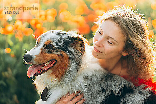 young woman and her australian shepherd dog