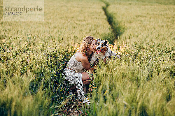 woman enjoying a sunny day with her in a green rye field