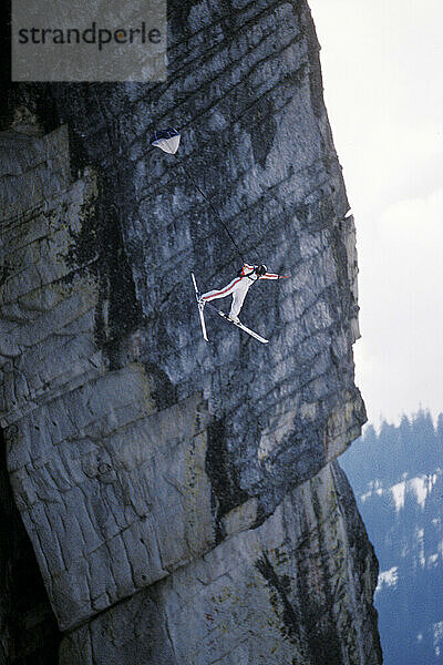 Jesse Hall doing a front flip while ski-BASE jumping at Lover's Leap  near Lake Tahoe. Ski-BASEing is a hybrid of extreme skiing and BASE jumping in which one skis off a steep cliff with a parachute.