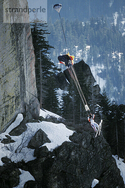 Jesse Hall ski-BASE jumping at Lover's Leap  near Lake Tahoe  California. Ski-BASEing is a hybrid of extreme skiing and BASE jumping in which one skis off a steep cliff with a parachute.