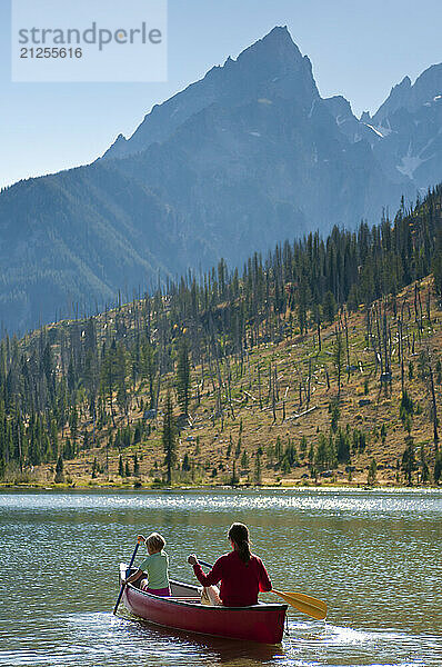 A mother and daughter paddle a canoe in Grand Teton National Park  Jackson Hole  Wyoming.