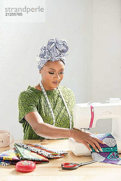 Woman sowing fabric on a sowing machine