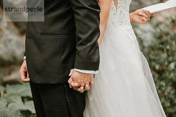 Bride and groom holding hands  exchanging vows