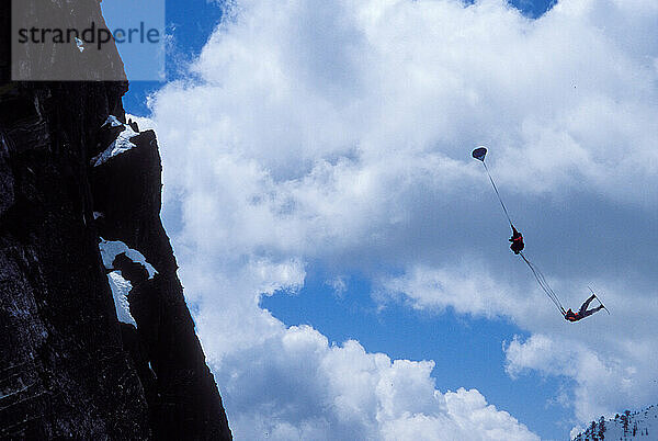 Mark Ridley pulling a back flip while Snowboard-BASE jumping at Lover's Leap  near Lake Tahoe. Board-BASEing is a hybrid of extreme snowboarding and BASE jumping in which one rides off a steep cliff with a parachute.