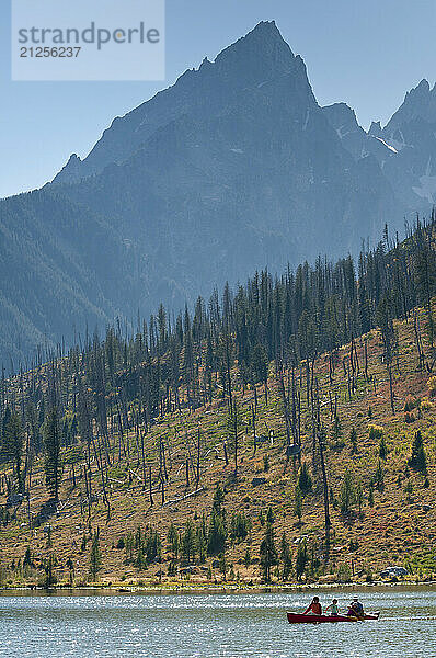 A family paddles a canoe in Grand Teton National Park  Jackson Hole  Wyoming.