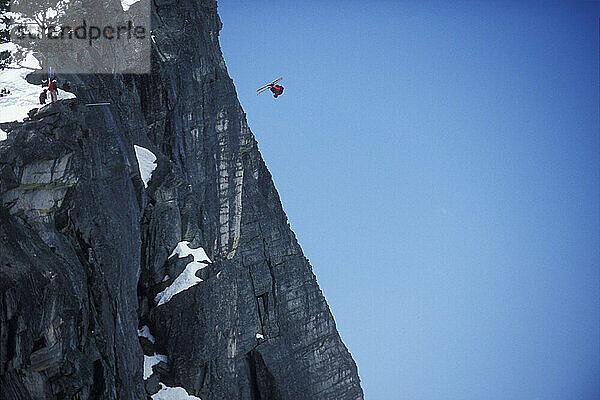 JT Holmes doing a front flip while ski-BASE jumping at Lover's Leap  near Lake Tahoe. Ski-BASEing is a hybrid of extreme skiing and BASE jumping in which one skis of a steep cliff with a parachute.