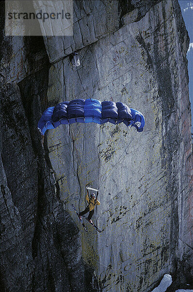 Max Kuszaj ski-BASE jumping at Lover's Leap  near Lake Tahoe. Ski-BASEing is a hybrid of extreme skiing and BASE jumping in which one skis off a steep cliff with a parachute.