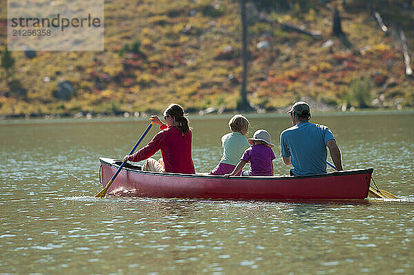 A family paddles a canoe in Grand Teton National Park  Jackson Hole  Wyoming.