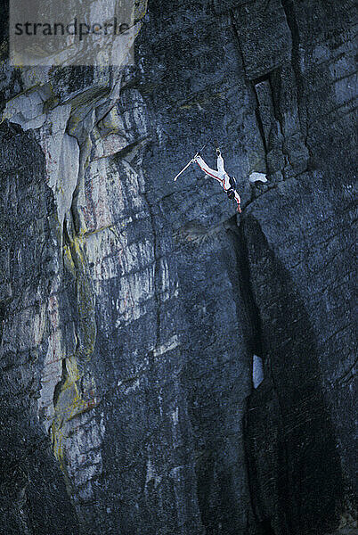 Jesse Hall doing a front flip while ski-BASE jumping at Lover's Leap  near Lake Tahoe. Ski-BASEing is a hybrid of extreme skiing and BASE jumping in which one skis off a steep cliff with a parachute.