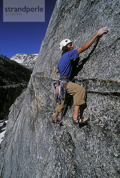 Kevin Jorgeson climbing Fantasia at Lover's Leap  a popular granite climbing destination near Lake Tahoe in California's Sierra Nevada mountains. The cliff is known for its distinct horizontal quartz dikes which make interesting climbing. This route is considered a risky mental test piece because of its lack of good cracks for protection. It was first climbed in 1973 by Royal Robbins and Ken Wilson.