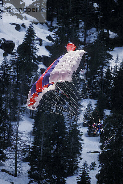 Miles Daisher ski-BASE jumping at Lover's Leap  near Lake Tahoe. Ski-BASEing is a hybrid of extreme skiing and BASE jumping in which one skis of a steep cliff with a parachute.