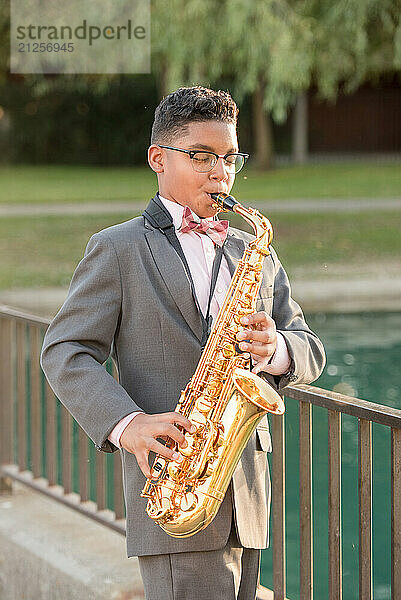 Boy playing the saxophone outside