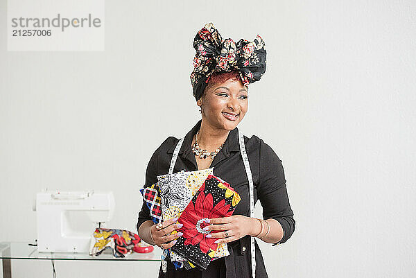 Woman holding her fabric and wearing a headwrap